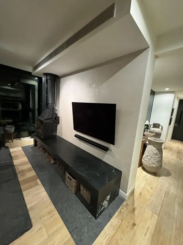 Living room with feature stone fireplace hearth