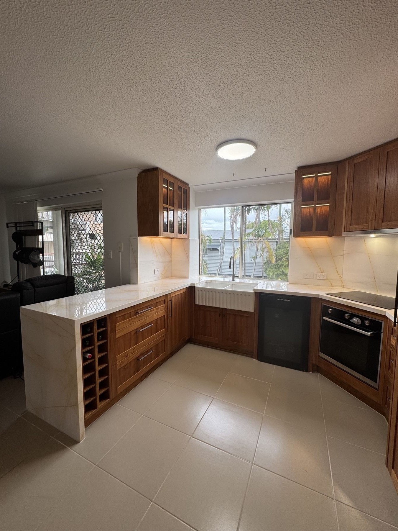 Butler pantry with marble splashback and walnut cabinets