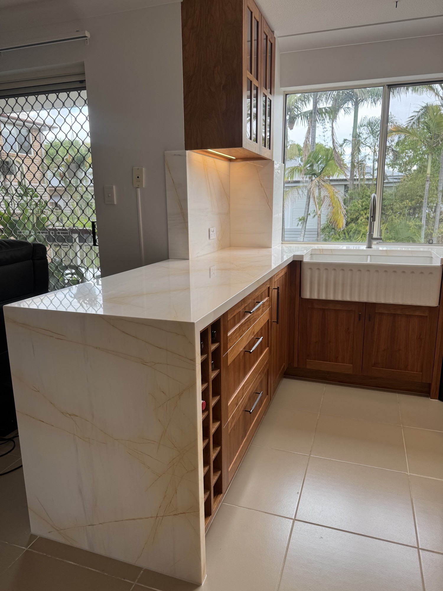 Walnut cabinetry and marble waterfall detail