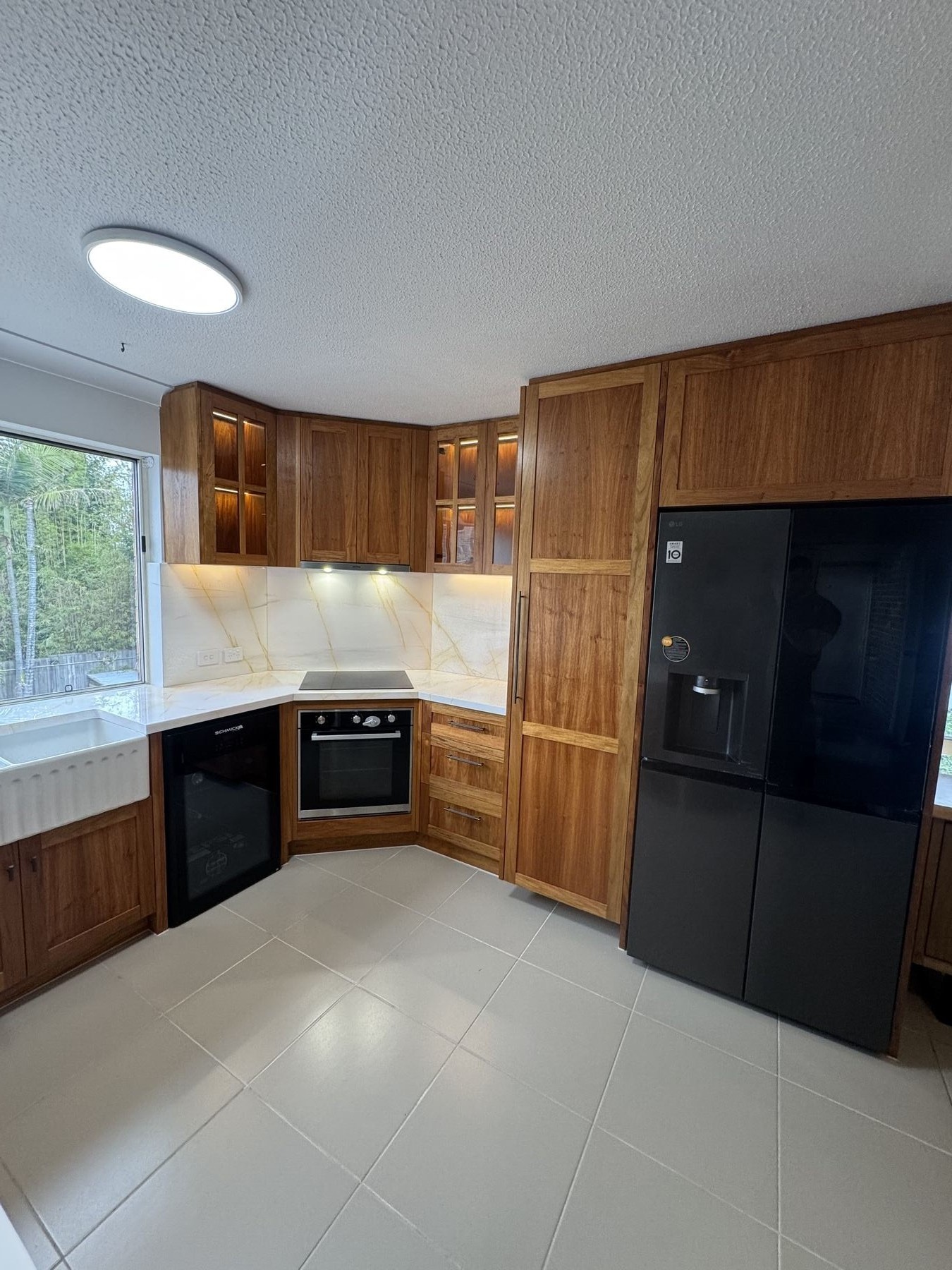 Appliance column with timber cabinetry