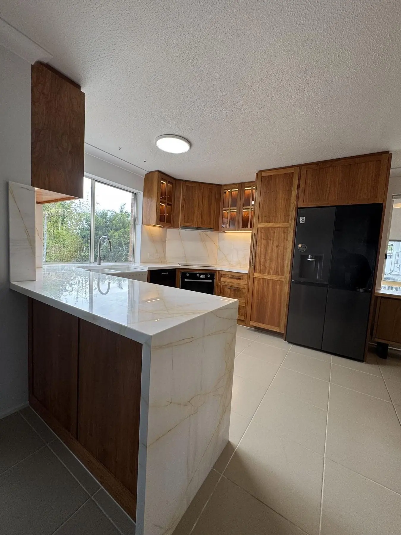 Kitchen renovation with timber cabinetry and marble benchtops