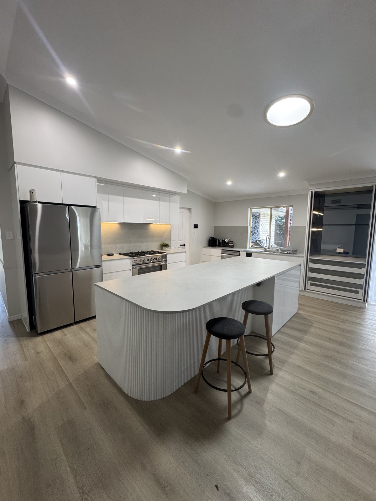 Completed kitchen renovation at Wellington Point with stone island and integrated appliances