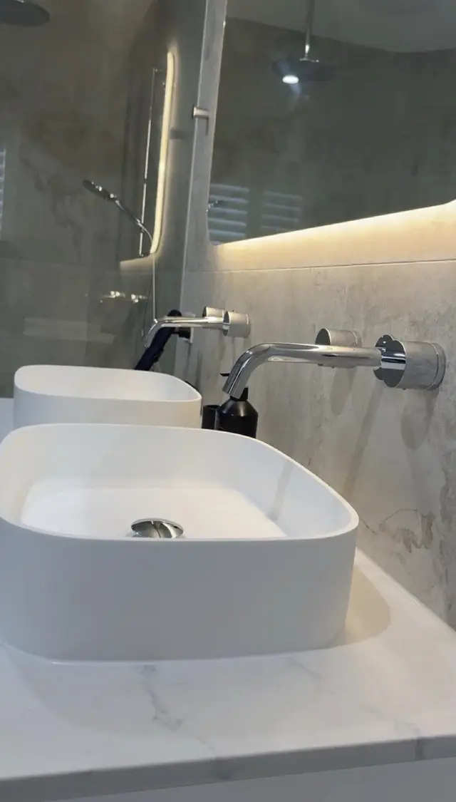 Twin vessel basins with wall-mounted chrome tapware