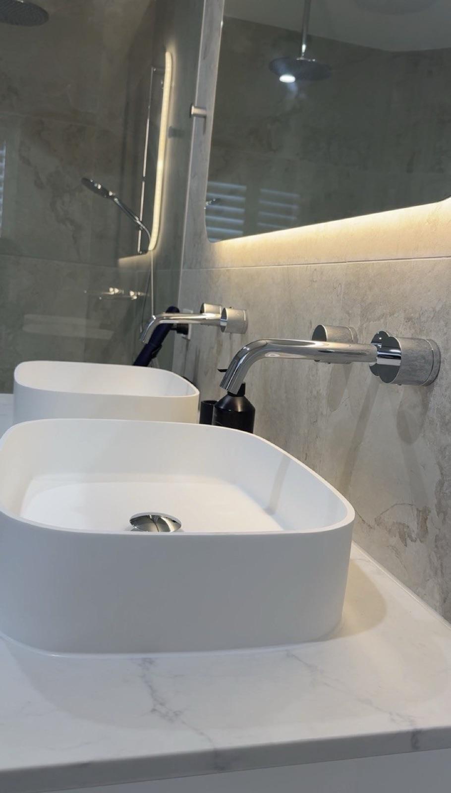 Twin vessel basins with wall-mounted chrome tapware